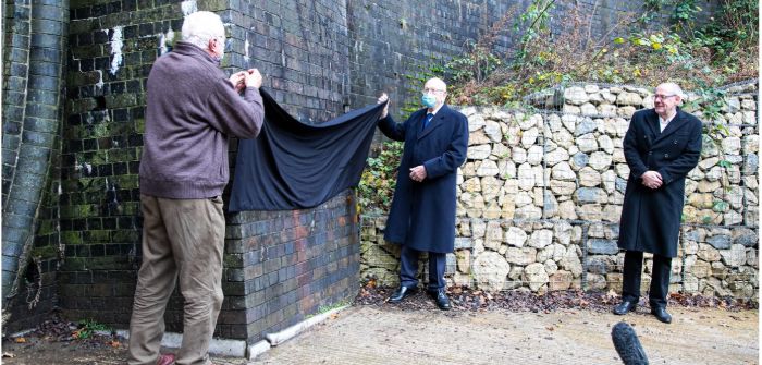 At the Catesby Tunnel opening, Mike Costin and Peter Wright unveil a plaque on the outside wall of the facility