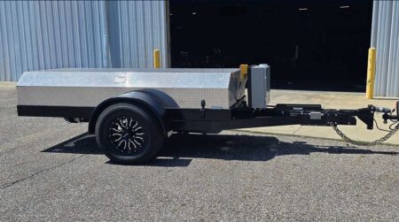 The Kubota ultra lightweight tow dynamometer shown on the tarmac outside a garage, in the sunshine.