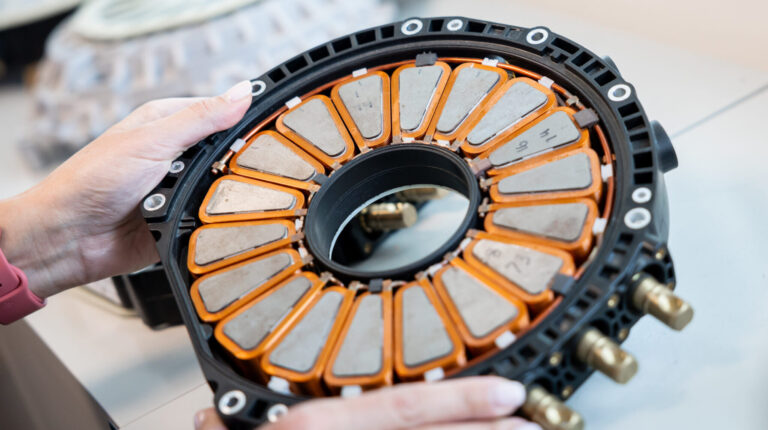 A Yasa staff member holds the company's prototype motor