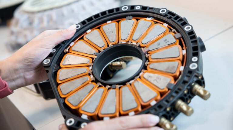 A Yasa staff member holds the company's prototype motor