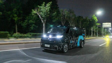 A WeRide robotaxi on a city street at night