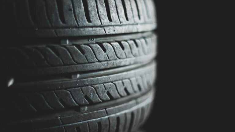 Stacked tires against a black background