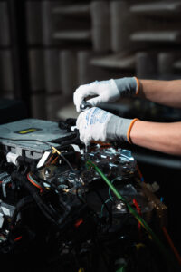 Hands of an engineer working on a hydrogen fuel cell.