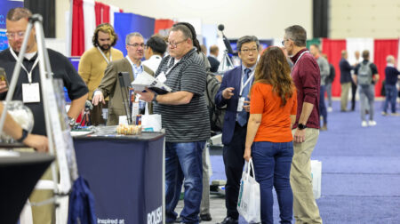 Exhibitors and visitors deep in discussion at Automotive Testing Expo