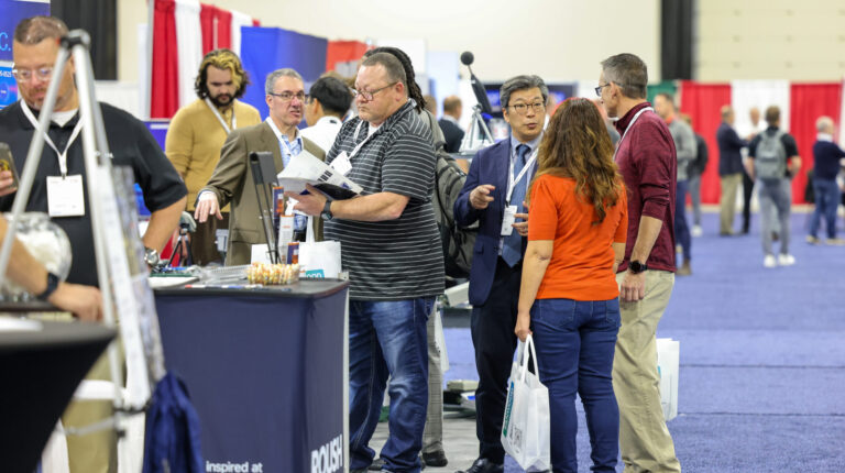 Exhibitors and visitors deep in discussion at Automotive Testing Expo