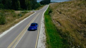 Mercedes-Benz driving on a long straight road. 
