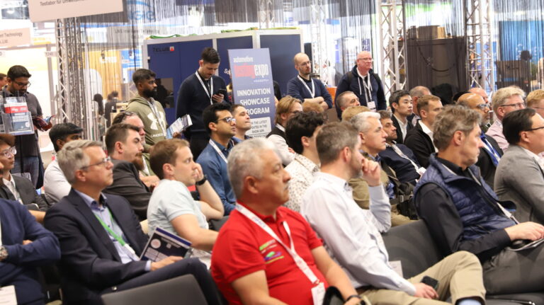 People sits in rows at a session at a trade conference