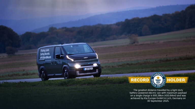 Kia’s PV5 Cargo sets eLCV range world record Kia PV5 Cargo on a road with Guinness World Record logo in the right hand corner of the image