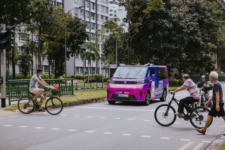 Singapore’s Punggol to host expanded autonomous shuttle tests by WeRide and Grab An Ai.R AV – a WeRide GXR – on a test run in Punggol, Singapore. The vehicle is at an intersection with bicycles and pedestrians crossing the road in front of it