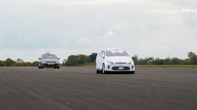 A car approaches the GST 120 Plus in a track test.