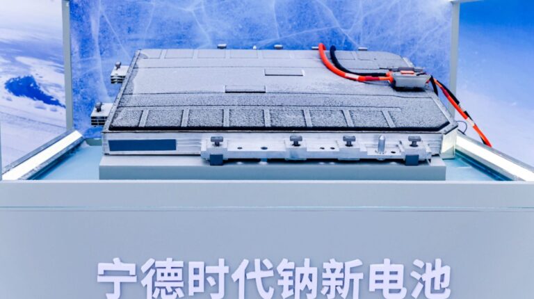 Close up of CATL's first mass-production sodium-ion battery. It is grey with red and black wires on one end.