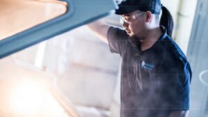 person lifting the vehicle bonnet and looking.