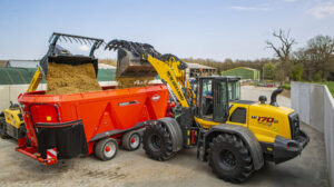 A yellow Kuhn agricultural vehicle at work.
