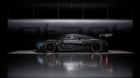 Profile photo of the new Genesis Magma GT3 Concept in a dark black showroom.