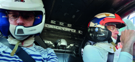 ATTI Awards panelist interview: Damian Harty Damian Harty sits in a race car with a colleague, both wearing helmets.