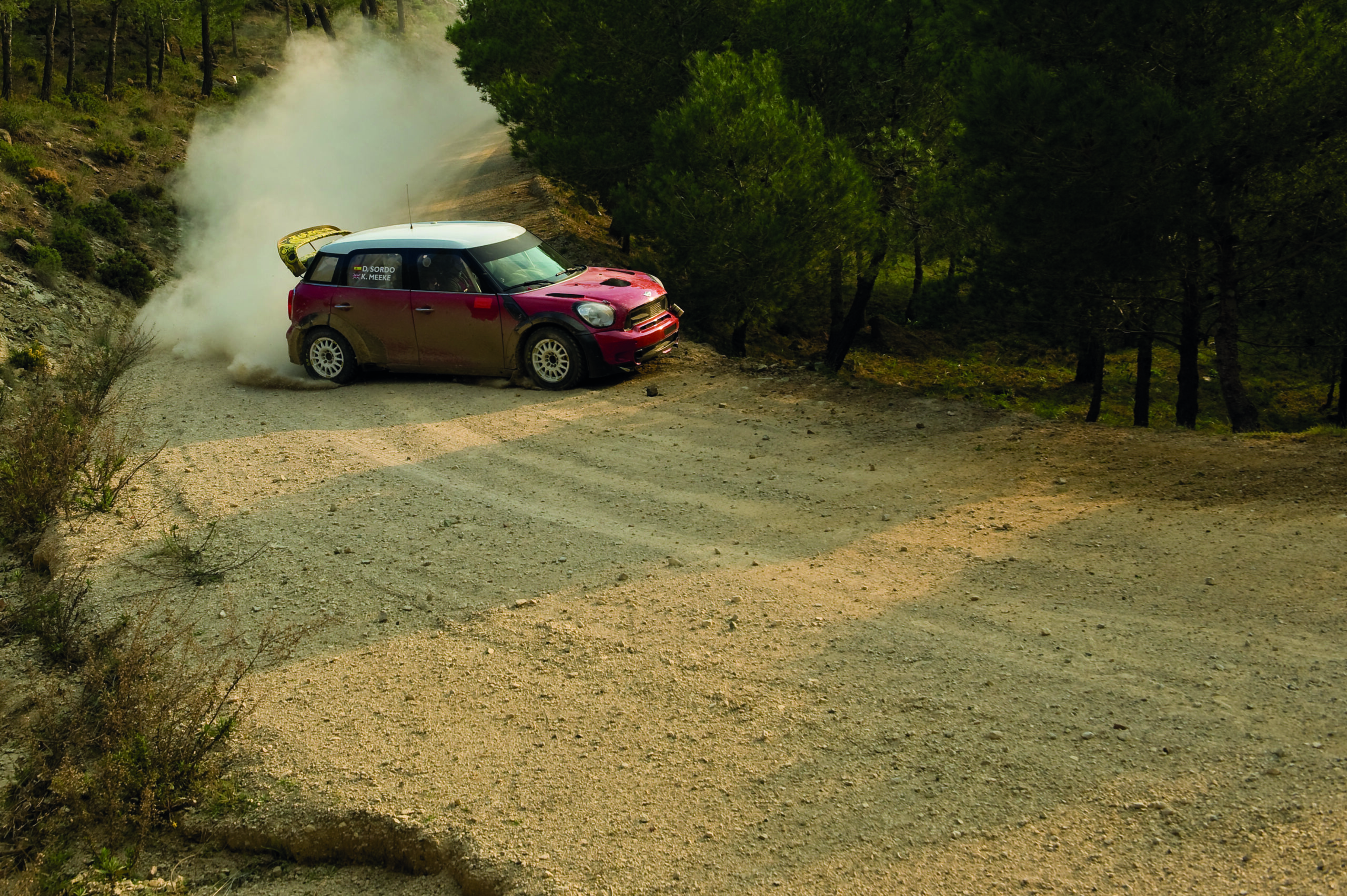 The Mini John Cooper Works rally car tackles a gravel stage.
