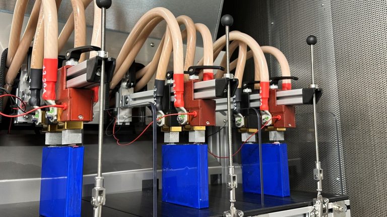 Electric vehicle batteries being tested in a laboratory.