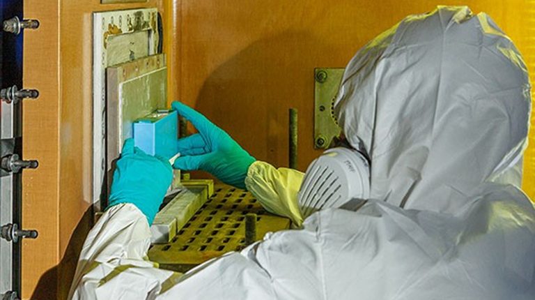 A Fraunhofer EMI employee placing battery inside x-ray.
