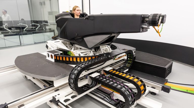 IAAPS integrates DiL simulator with 1,800kW powertrain test facility The Ansible Motion Delta S2 simulator, with a test engineer sitting in the cockpit.